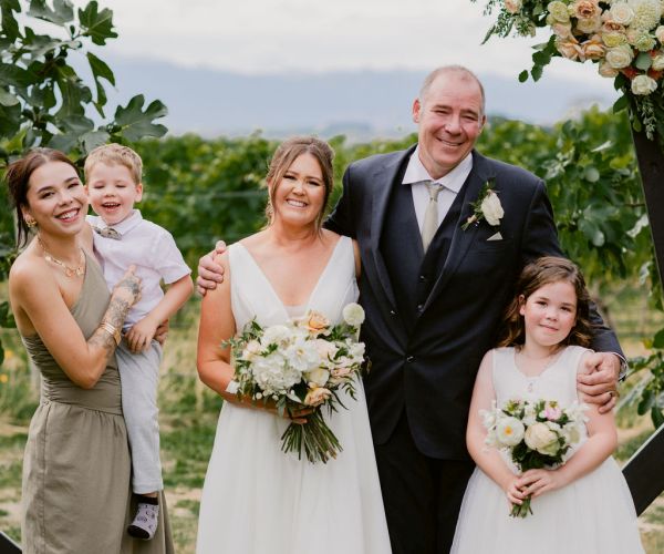 Image of a newly married couple with three children aged from 3 to 20.